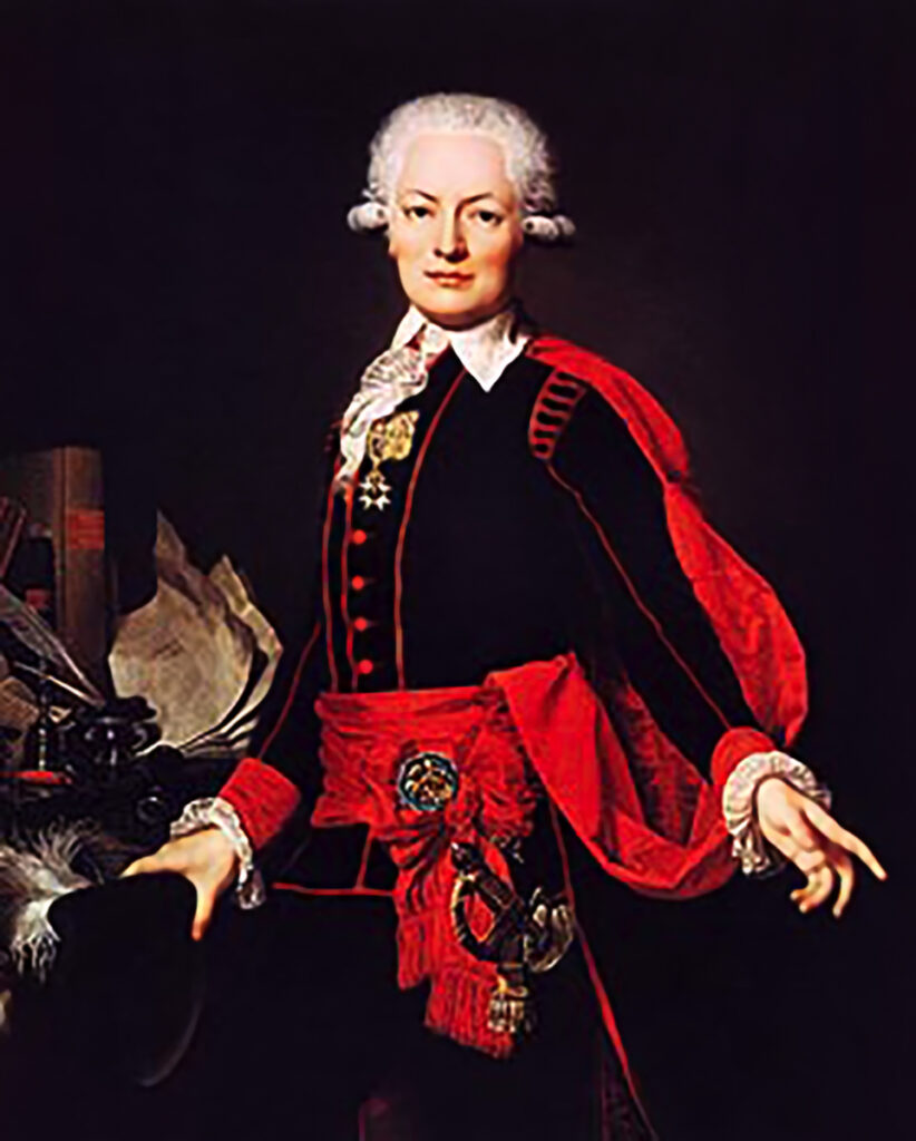 An oil painting of Germaine de Staël's husband and diplomat, Erik Magnus Staël von Holstein (1749-1802). He stands in a black and red outfit looking at the viewer and gesticulating as if making a point.