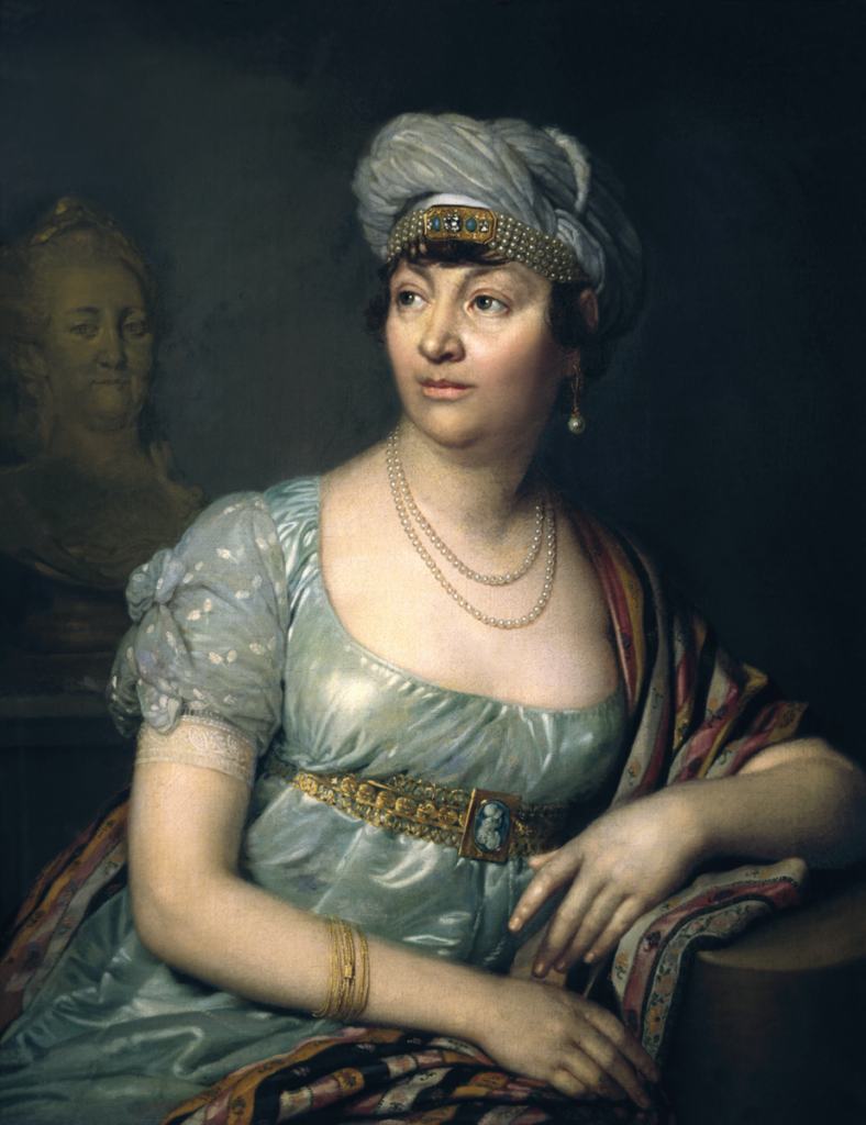 Oil portrait of Germaine de Staël later in life reclining and wearing a jeweled turban.
